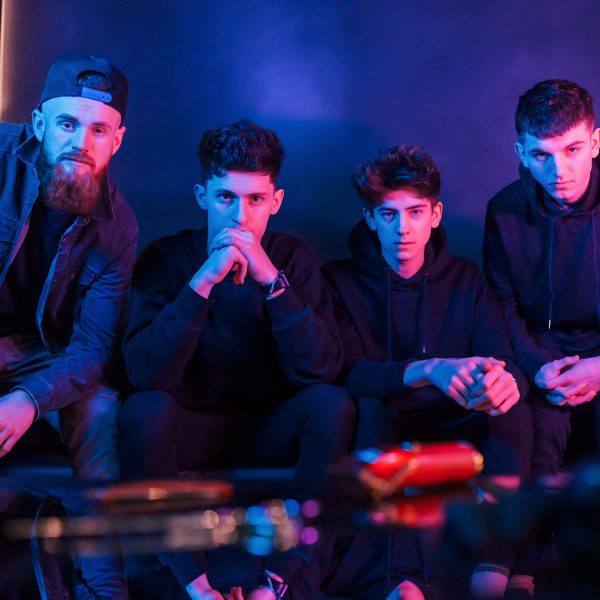Group of people is together in the studio with futuristic neon lighting